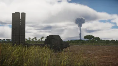 A missile vehicle stands in a field beneath a distant mushroom cloud.