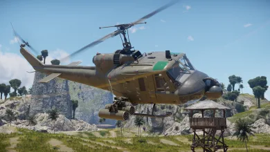 An armed UH-1C helicopter flies above a tropical landscape in War Thunder.
