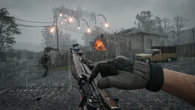 A first-person WARDOGS soldier aims a rifle across a rain-soaked battlefield as a building burns.