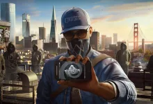 A masked DedSec member holds up a smartphone against a San Francisco skyline and the Golden Gate Bridge.