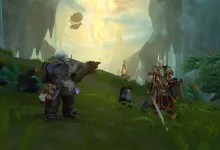 Several World of Warcraft characters stand in a cavern beneath a brilliant golden crystal.