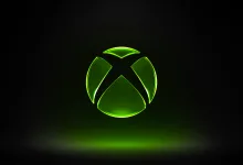 A glowing green Xbox logo against a black background.